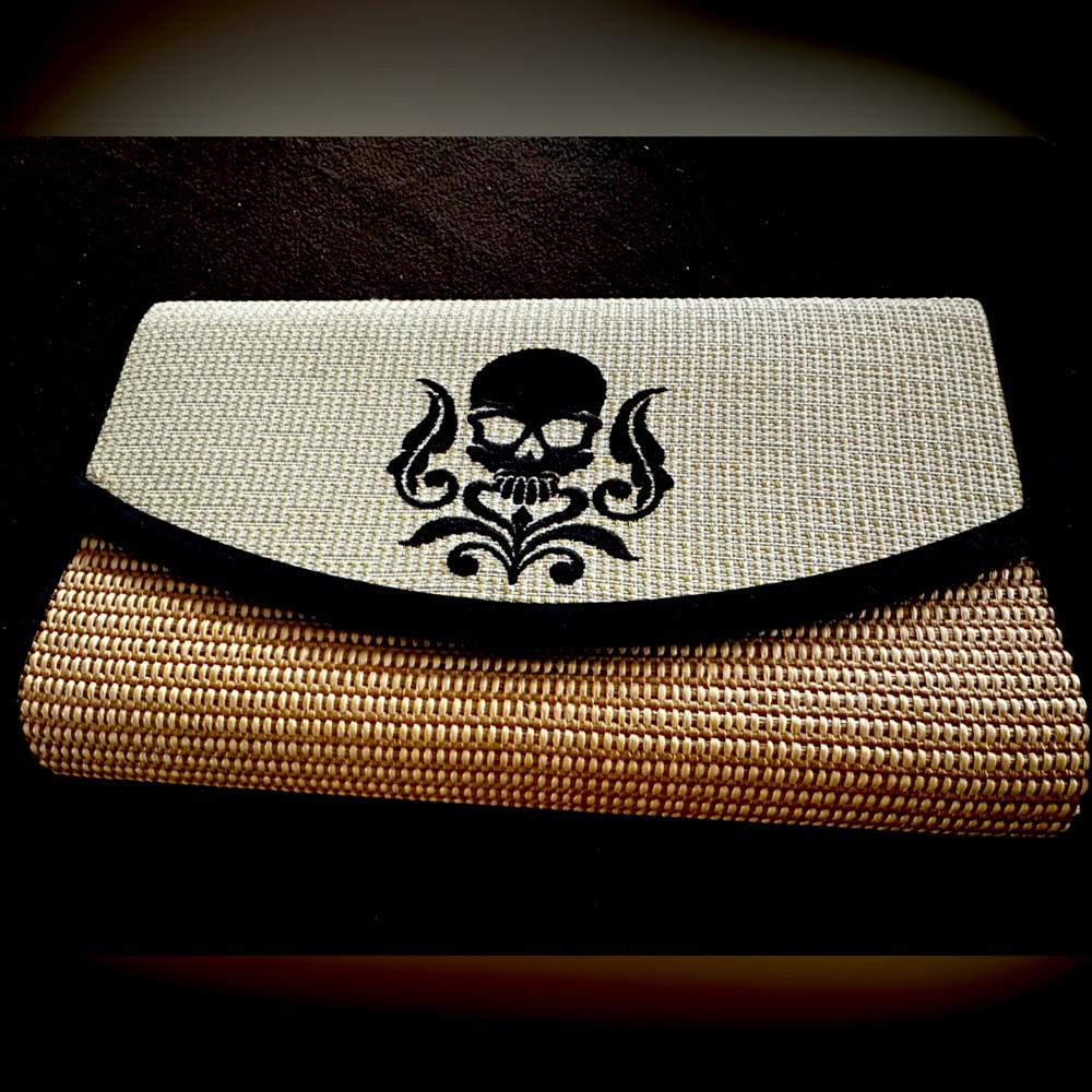 Stylish clutch purse with skull design.